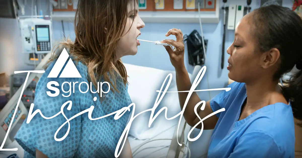 Nurse in blue scrubs working with a sick patient