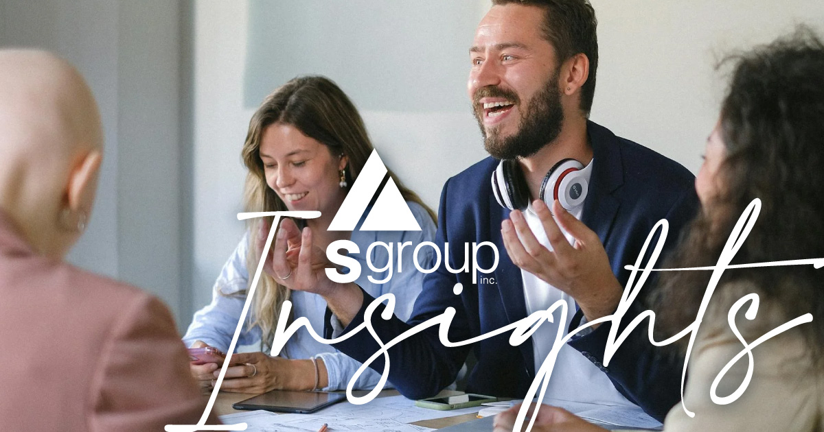 photo of happy, engaged employees sitting around a table